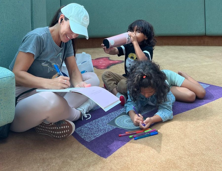 Neysha escribiendo junto a sus hijos
